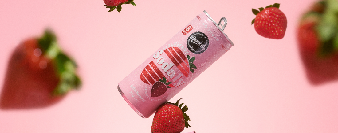 can of Strawberry Sodaly surrounded by strawberries