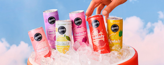 Cans of Remedy Sodaly in the following flavours from left to right: Guava Sodaly, Passionfruit Sodaly, Yuzu Lemon Sodaly, Raspberry Sodaly, Blood Orange Sodaly, Pineapple Sodaly